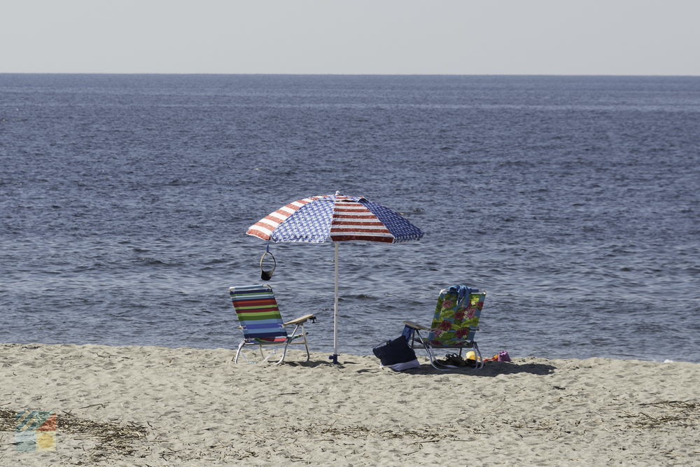 A patriotic umbrella and chairs on Holden Beach