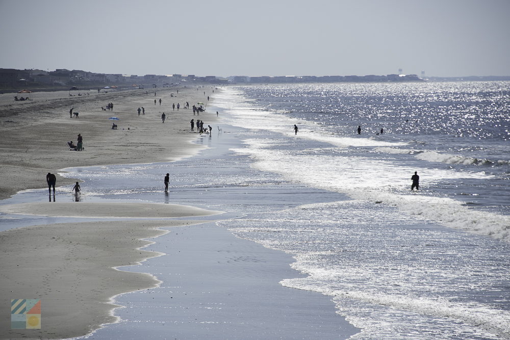 Visitors stroll and relax on Holden Beach